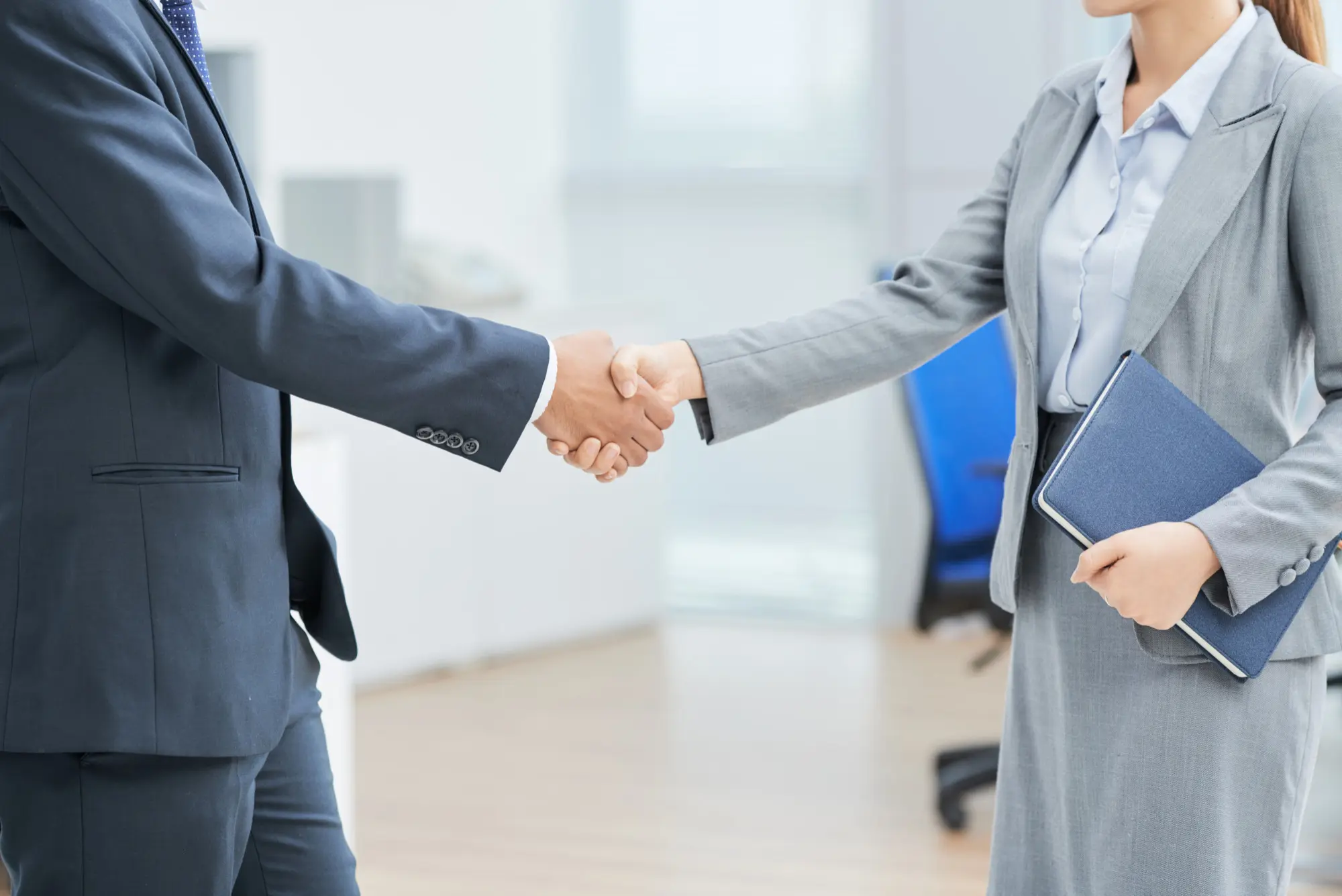 Two people shaking hands after a meeting