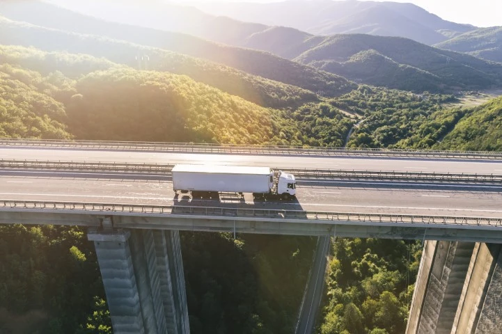 A truck driving over a bridge.